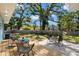 Backyard with seating, manicured lawn, and mature trees, perfect for relaxing at 1400 23Rd S Ave, St Petersburg, FL 33705