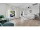 Spacious bedroom boasts hardwood floors, white walls, white bedding, and lots of natural light at 1400 23Rd S Ave, St Petersburg, FL 33705