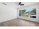 Bright bedroom with light wood floors, large window, and ceiling fan at 1400 23Rd S Ave, St Petersburg, FL 33705