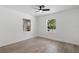 Clean and bright bedroom offers hardwood floors, white walls, with large windows on either side of the room at 1400 23Rd S Ave, St Petersburg, FL 33705