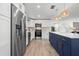 Modern kitchen features stainless steel appliances, white cabinets, a center island and hardwood floors at 1400 23Rd S Ave, St Petersburg, FL 33705