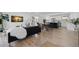 Open-concept living room featuring hardwood floors, modern decor, and ample natural light at 1400 23Rd S Ave, St Petersburg, FL 33705