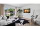 Bright living room with hardwood floors, modern furnishings, and a large window offering natural light at 1400 23Rd S Ave, St Petersburg, FL 33705