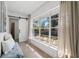 Bright sitting area with bench seat offers backyard views through expansive window and access to adjacent room at 1400 23Rd S Ave, St Petersburg, FL 33705