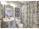 Well-maintained bathroom featuring classic fixtures, patterned shower curtain, and easy access from the bedroom at 1400 Gandy N Blvd # 1504, St Petersburg, FL 33702