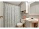 The bathroom features a shower with a patterned curtain, a pedestal sink, and cabinet storage at 1400 Gandy N Blvd # 1504, St Petersburg, FL 33702
