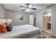Cozy bedroom featuring a ceiling fan, serene gray walls, and an ensuite bathroom for added privacy at 1400 Gandy N Blvd # 1504, St Petersburg, FL 33702