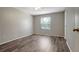 This light-filled bedroom features a ceiling fan, wood-look floors, and a window at 1400 Gandy N Blvd # 1504, St Petersburg, FL 33702