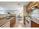 Functional kitchen area with a view to the dining area, featuring essential appliances and ample counter space at 1400 Gandy N Blvd # 1504, St Petersburg, FL 33702