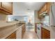 Functional kitchen area with view to the dining area, featuring essential appliances and ample counter space at 1400 Gandy N Blvd # 1504, St Petersburg, FL 33702