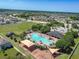 Aerial view showing community pool, clubhouse, playground and residential houses at 14614 Rannoch Moor Pl, Wimauma, FL 33598