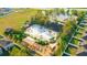 Aerial view of the community pool with a playground, clubhouse, and green spaces at 14614 Rannoch Moor Pl, Wimauma, FL 33598