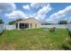 Spacious backyard with a white fence and a screened-in patio for outdoor enjoyment at 14614 Rannoch Moor Pl, Wimauma, FL 33598