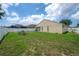 View of the backyard, complete with a fire pit and outdoor chairs, enclosed by a white privacy fence at 14614 Rannoch Moor Pl, Wimauma, FL 33598