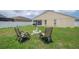 This backyard features a fire pit area, chairs and is surrounded by a privacy fence for outdoor entertainment at 14614 Rannoch Moor Pl, Wimauma, FL 33598