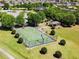Aerial view of community basketball court with green surface and metal fencing at 14614 Rannoch Moor Pl, Wimauma, FL 33598