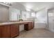 Bathroom featuring a double vanity, bathtub, walk-in shower, and a window at 14614 Rannoch Moor Pl, Wimauma, FL 33598