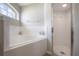Bright bathroom featuring a soaking tub, walk-in shower, and a window at 14614 Rannoch Moor Pl, Wimauma, FL 33598