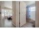 View into a bathroom featuring a tub with colorful shower curtain from a bedroom at 14614 Rannoch Moor Pl, Wimauma, FL 33598