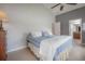 Comfortable bedroom with tile flooring, a ceiling fan, and views of the bathroom at 14614 Rannoch Moor Pl, Wimauma, FL 33598