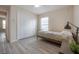 Cozy bedroom with a twin bed, large closet, and a bright window at 14614 Rannoch Moor Pl, Wimauma, FL 33598