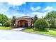 Attractive community clubhouse features stone archway, landscaped grounds, and inviting entrance at 14614 Rannoch Moor Pl, Wimauma, FL 33598