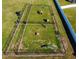 Aerial view of dog park featuring two fenced in areas complete with shelters, play structures and water stations at 14614 Rannoch Moor Pl, Wimauma, FL 33598