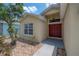 Close-up of the front door and entryway with manicured landscaping at 14614 Rannoch Moor Pl, Wimauma, FL 33598