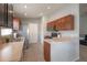 Bright, functional kitchen featuring wood cabinets, breakfast bar, and modern appliances at 14614 Rannoch Moor Pl, Wimauma, FL 33598