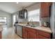 Kitchen with stainless steel dishwasher, double sink, and dark cabinets at 14614 Rannoch Moor Pl, Wimauma, FL 33598