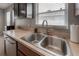 Functional kitchen sink area with stainless steel appliances and ample counter space at 14614 Rannoch Moor Pl, Wimauma, FL 33598