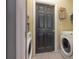 Functional laundry room with washer and dryer, and convenient storage shelves at 14614 Rannoch Moor Pl, Wimauma, FL 33598