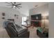 Relaxing living room features tile flooring, a ceiling fan, and a comfortable leather sofa at 14614 Rannoch Moor Pl, Wimauma, FL 33598