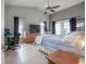 Bedroom with vaulted ceiling, neutral paint, ceiling fan, and access to the lanai at 14614 Rannoch Moor Pl, Wimauma, FL 33598