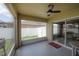 Enjoyable enclosed patio with a ceiling fan and scenic backyard views, perfect for relaxation at 14614 Rannoch Moor Pl, Wimauma, FL 33598