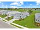 Community aerial showcasing well-maintained homes and lush landscaping with a golf course in the background at 15817 San Lazzaro Ave, Bradenton, FL 34211