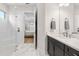 Bathroom featuring a glass shower and vanity with open doorway to the main bedroom with an outdoor view at 15817 San Lazzaro Ave, Bradenton, FL 34211