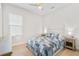 Bright bedroom featuring a comfortable bed with blue accents and light wood floors at 15817 San Lazzaro Ave, Bradenton, FL 34211