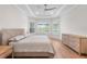 Beautiful bedroom featuring tray ceilings, wood floors and large windows with a great view of the property at 15817 San Lazzaro Ave, Bradenton, FL 34211