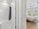 Bathroom and bedroom showcasing neutral tones, wood floors, and natural light at 15817 San Lazzaro Ave, Bradenton, FL 34211