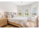 Bright bedroom with wood floors, neutral tones, natural light, and simple decor at 15817 San Lazzaro Ave, Bradenton, FL 34211