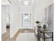 Bright entryway with white walls, wood floors, decorative table, and a glass front door at 15817 San Lazzaro Ave, Bradenton, FL 34211