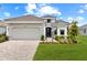 Charming single-story home featuring a two-car garage, gray tile roof, and well-kept lawn at 15817 San Lazzaro Ave, Bradenton, FL 34211