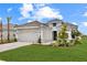 Charming single-story home showcasing a gray tile roof, manicured lawn, and beautiful landscaping at 15817 San Lazzaro Ave, Bradenton, FL 34211