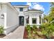 Close up of a charming single-story home featuring a gray tile roof and beautiful landscaping at 15817 San Lazzaro Ave, Bradenton, FL 34211