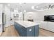 Bright kitchen featuring a large island with white countertops and stainless steel appliances at 15817 San Lazzaro Ave, Bradenton, FL 34211