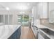 Contemporary kitchen featuring a large island and sliding glass doors to a pool area at 15817 San Lazzaro Ave, Bradenton, FL 34211