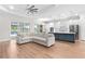 This open living space features ample seating, an island, and an exit to a lanai with pool at 15817 San Lazzaro Ave, Bradenton, FL 34211