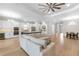 This open living space features a modern kitchen, ample seating, and an island with lighting at 15817 San Lazzaro Ave, Bradenton, FL 34211