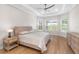Bright main bedroom with tray ceiling, comfortable bed and stunning views of the outdoors at 15817 San Lazzaro Ave, Bradenton, FL 34211